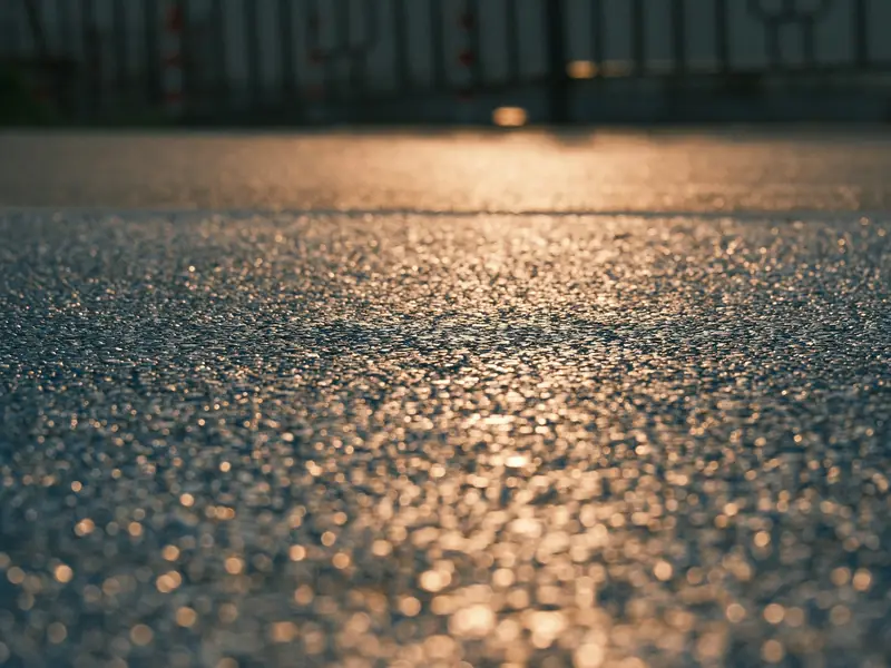 Close up of dark asphalt catching the light