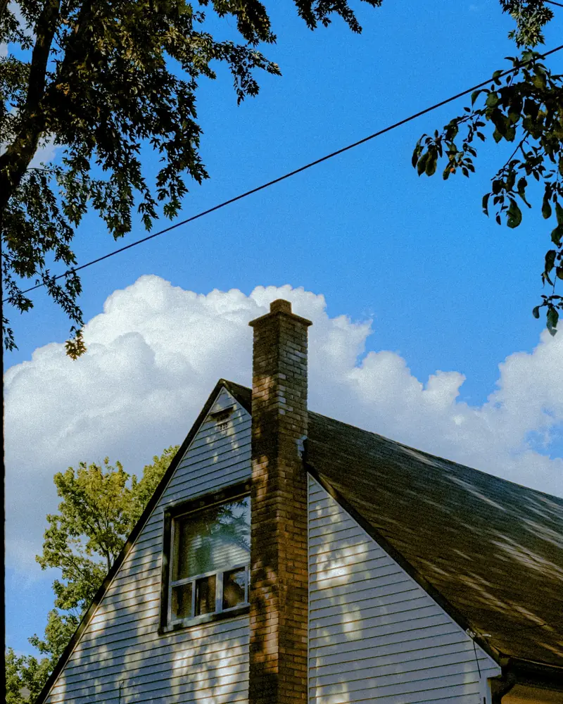 White sided house under a blue sky
