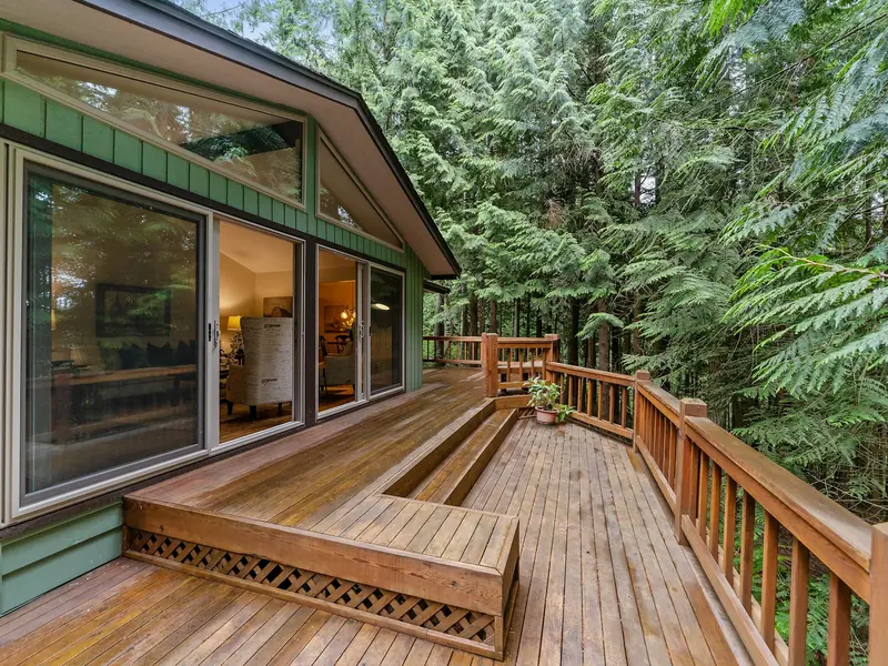 Wooden deck and railing beside a house